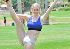 Sporty blonde stripping outdoors